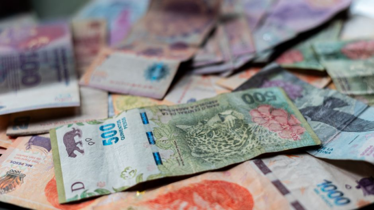 Billetes de pesos argentinos y dólares representando el mercado cambiario